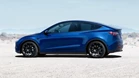 Side-view-of-blue-2023-Tesla-Model-Y-highlighting-its-release-date-and-price.jpg